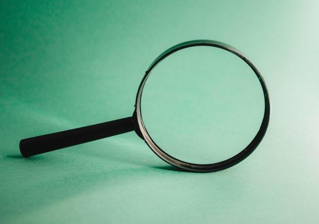 A magnifying glass on a green background